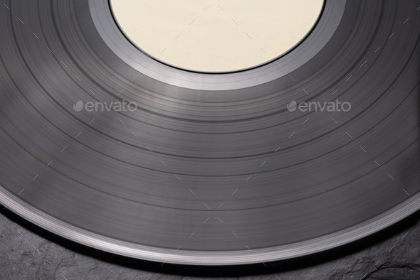 Close-up shot of vinyl record on black background.