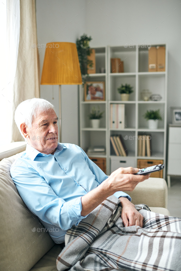 Elderly man watching tv alone