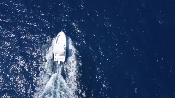Aerial top down tracking shot of passing luxury yacht on Mediterranean Sea in summer.Slow-motion foo alt