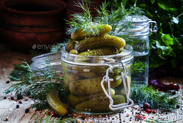 Pickled small cucumbers gherkins in a glass jar