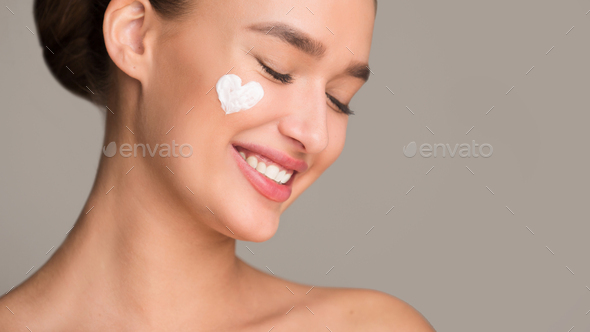 Anti wrinkle cream. Woman with cream in heart shape