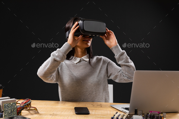 Mixed race female wearing Virtual Reality headset