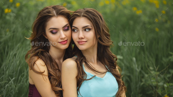 Fashion Portrait Photo of Two Women Against Green Grass Meadow on Nature - Stock Photo - Images