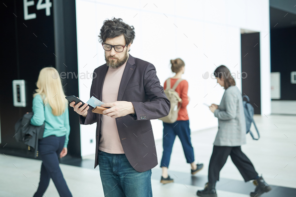 Man Checking Boarding Pass Information - Stock Photo - Images