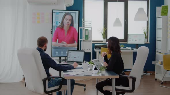 Colleagues Talking to Woman on Video Call for Business Meeting alt