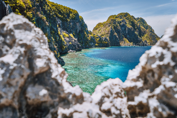 El Nido, Palawan, Philippines. Matinloc island and tapiutan strait framed by limestone sharp rocks - Stock Photo - Images
