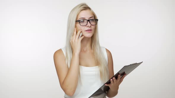 Caucasion Blond Female Office Worker Pleasantly Talking Business Using Mobile Phone Holding alt