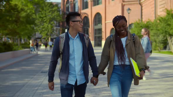Diverse Student Couple Going To College Class Walking Through University Campus alt