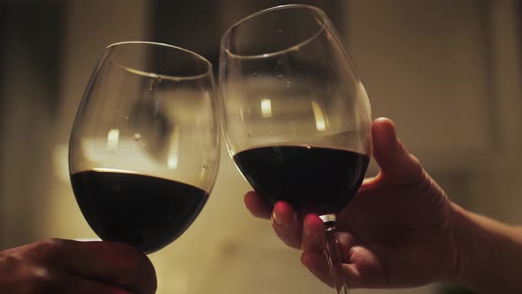 Romantic date dinner, couple drinking wine making cheers with glasses during dinner at home. alt