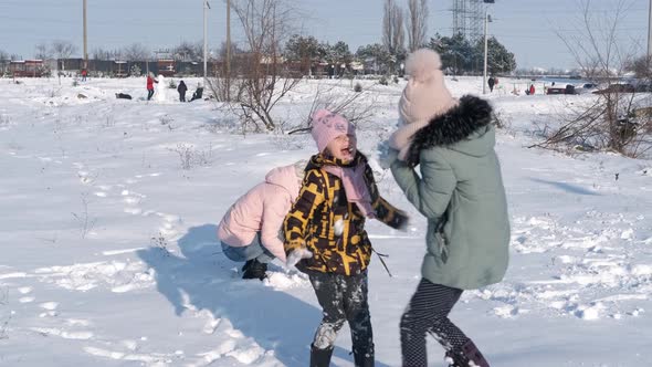 Family play with snow balls. alt