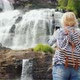 A Young Woman Photographs a Picturesque Tvindefossen Waterfall in Norway - a Trip To Scandinavia and - VideoHive Item for Sale