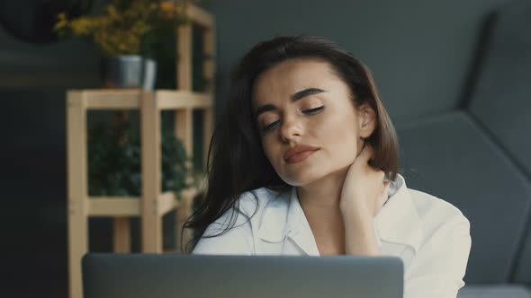 Tired and Stressed Freelnacer in Loft Cafe with Laptop alt