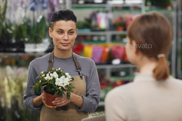 Modern Young Woman Selling Flowers in Shop