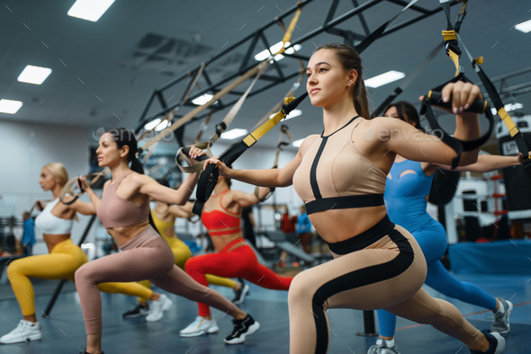Group of attractive women doing exercise in gym Stock Photo by