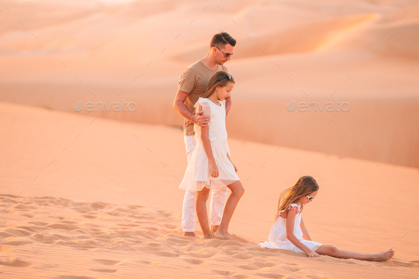 People among dunes in desert in United Arab Emirates