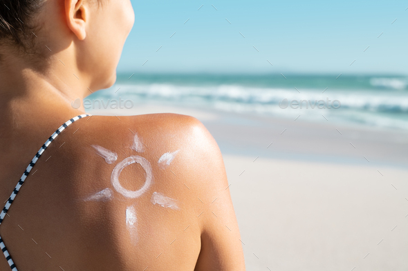 Woman with sun shaped sunscreen on shoulder Stock Photo by Rido81