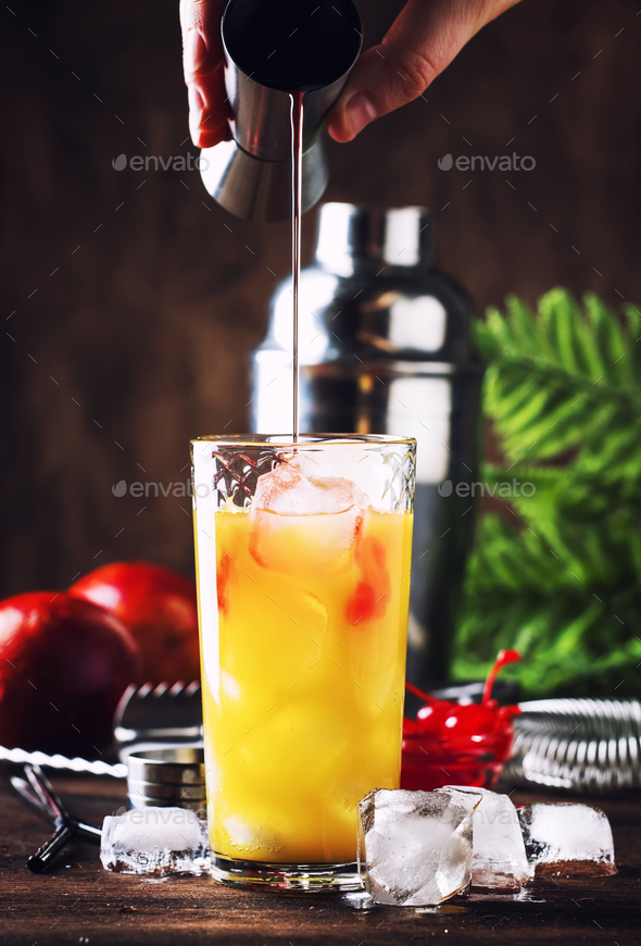 Summer tequila sunrise cocktail with silver tequila, grenadine syrup, orange and ice