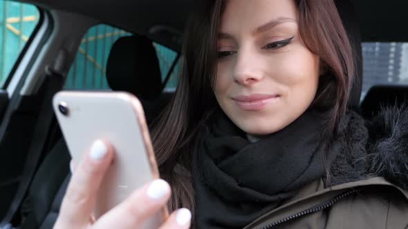 Online Video Chat by Young Female Sitting in Car alt