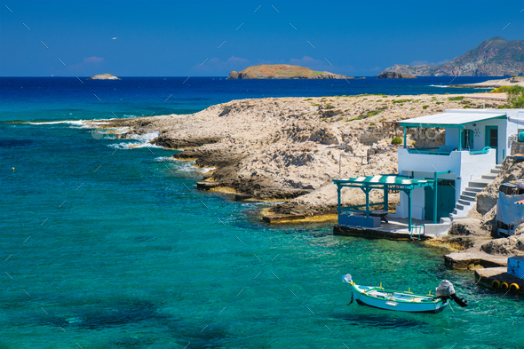 Crystal clear blue water at MItakas village beach, Milos island, Greece - Stock Photo - Images