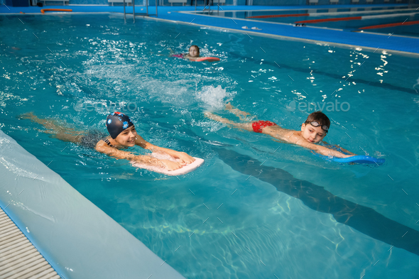 Children swimming group, workout in the pool