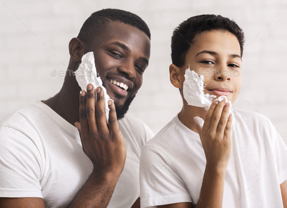 Happy African American Father And Son Putting Shaving Foam On Faces