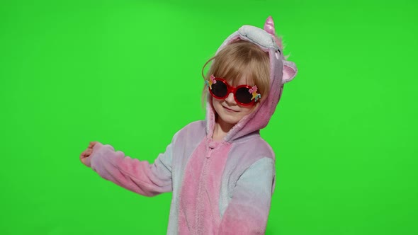 Little Child Girl Smiling Dancing Making Gun Gesture with Hands in Unicorn Pajamas on Chroma Key alt