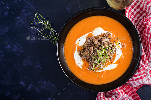 Delicious cream of pumpkin soup with roasted forcemeat made of beef minced meat - Stock Photo - Images