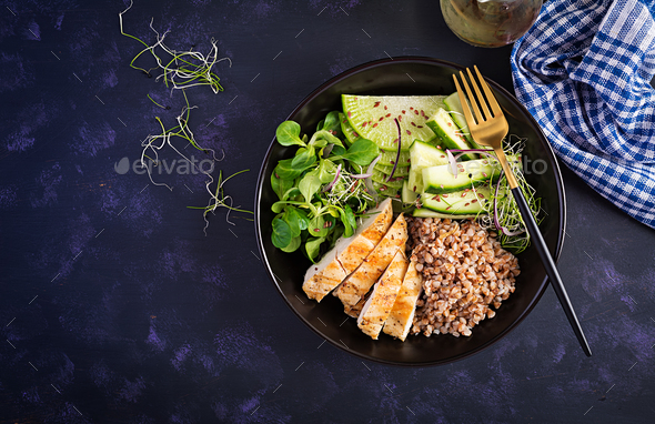 Buddha bowl with buckwheat porridge, grilled chicken fillet, corn salad, microgreens and daikon - Stock Photo - Images