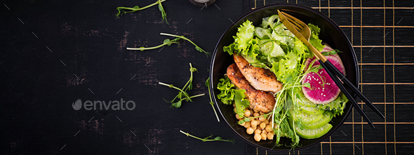 Buddha bowl dish with chicken fillet, chickpea, cucumber, radish, fresh lettuce salad, pea sprouts - Stock Photo - Images