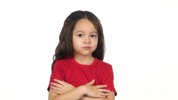 Little Girl Crosses Hands Posing at White Background. Slow Motion alt