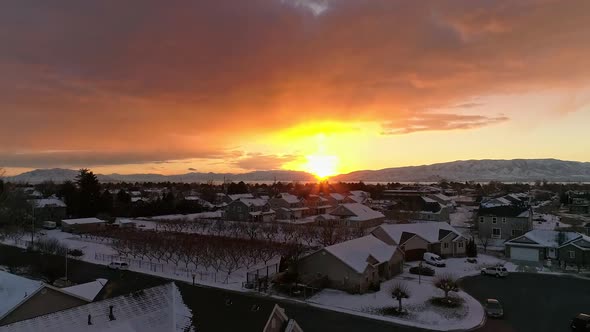 Aerial flying up and over tree flying towards colorful sunset alt
