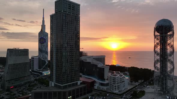 Aerial shot at sunset of modern buildings in downtown of Batumi. Georgia 2022 summer alt