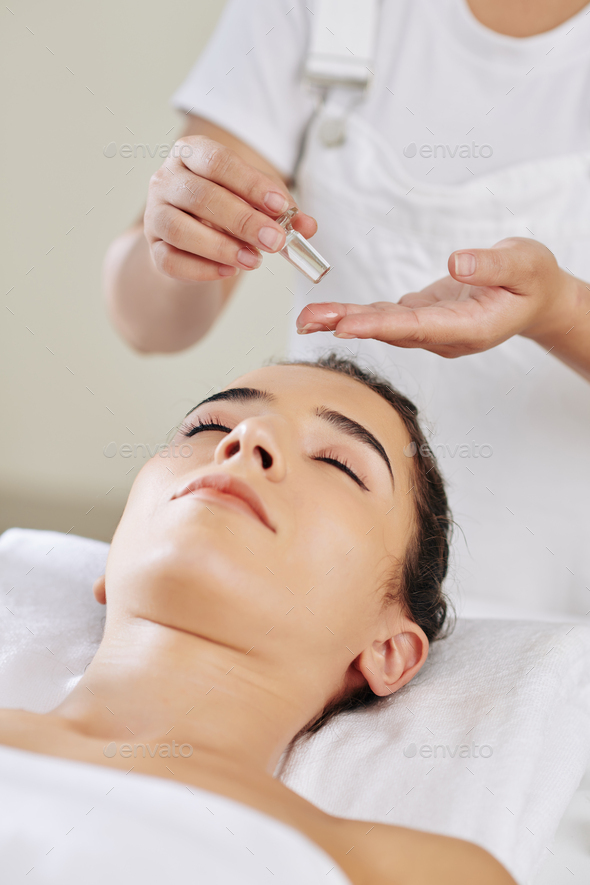 Beautician applying massage oil