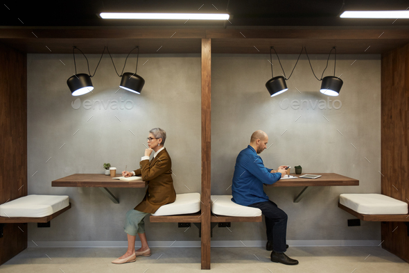 Modern Adult People in Separate Cafe Booths