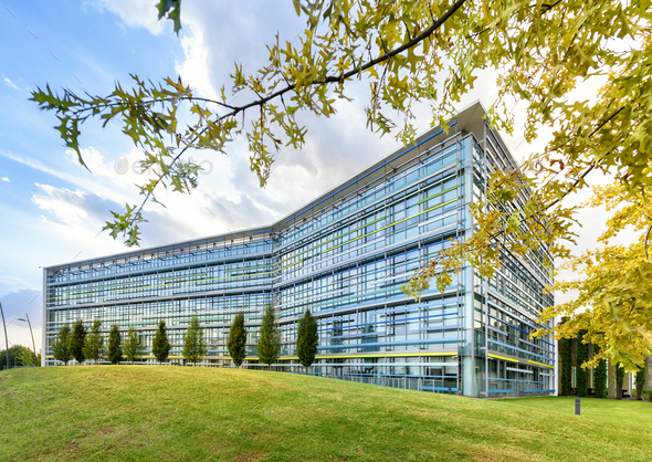 Modern glass fronted office building in spring