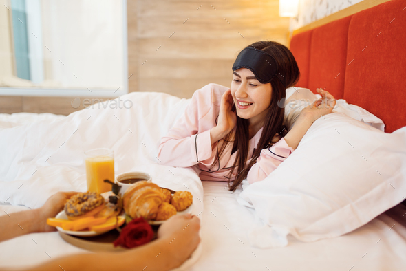 Romantic love couple, breakfast and rose in bed