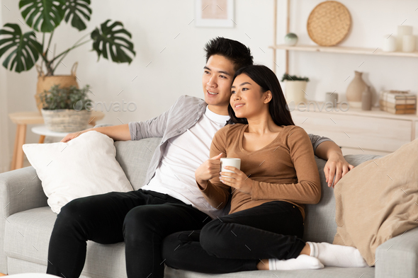 Korean couple resting at home and watching tv