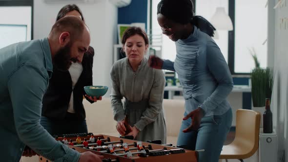 Woman Playing Foosball Game Table and Winning After Work alt