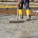 bricklayer who level the freshly poured concrete to lay the foundations of a building - PhotoDune Item for Sale