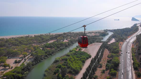 Close-up Flight Next To the Uphill Funicular with the Coast in the Background 