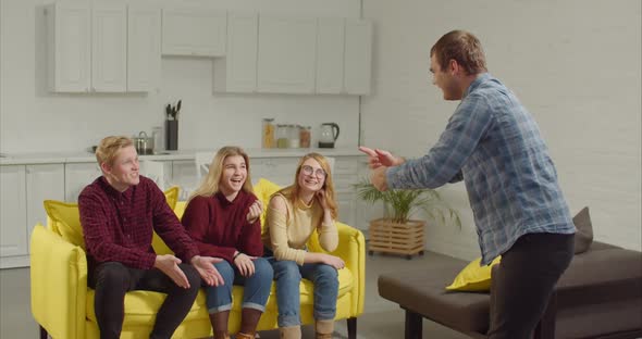 Man Acting Out a Word in the Game of Charades alt