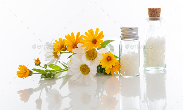 Wild flowers and homeopathic globules isolated on white background Stock  Photo by rawf8