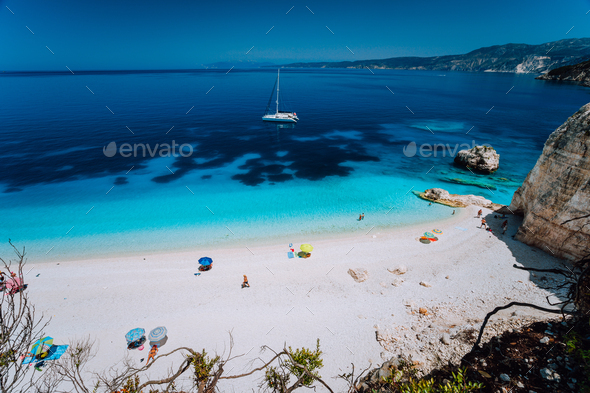 Fteri beach, Cephalonia Kefalonia, Greece. White catamaran yacht in clear deep blue sea water with - Stock Photo - Images