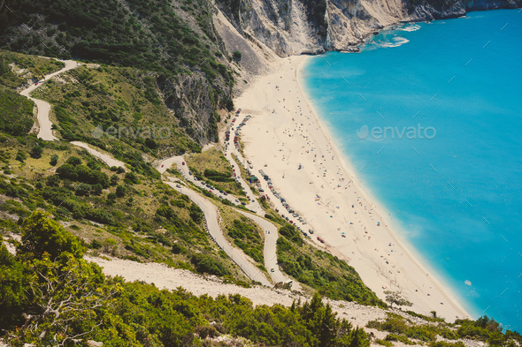 Serpentine road to famous Myrtos Beach with many tourists, Kefalonia, Greece - Stock Photo - Images