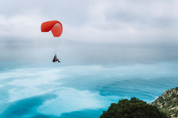 Paraglider against blue sea with foggy clouds. Kefalonia island, Greece. recreation hobby activity