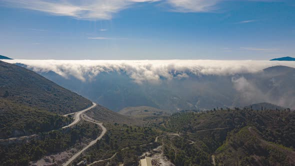 Aerial drone hyperlapse timelapse of rolling clouds over mountains in Spain in winter alt