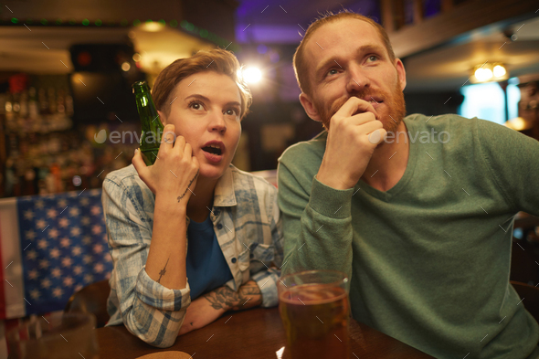 Young couple watching sport match