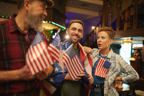 People with American flags in the bar