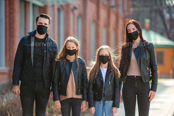 Family wearing masks to protect against Coronavirus and gripp