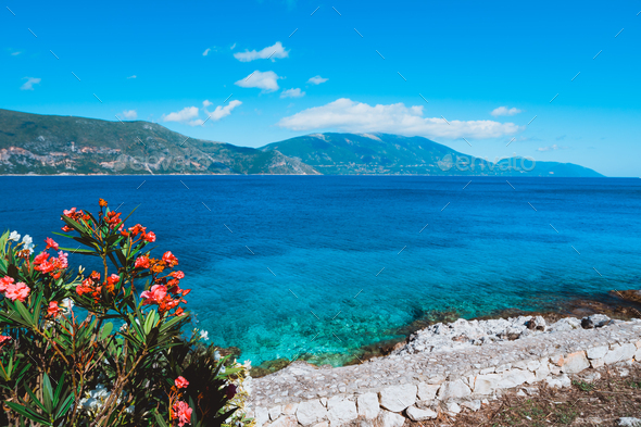 Panorama of crystal clear transparent blue turquoise teal Mediterranean seascape in Fiskardo town - Stock Photo - Images